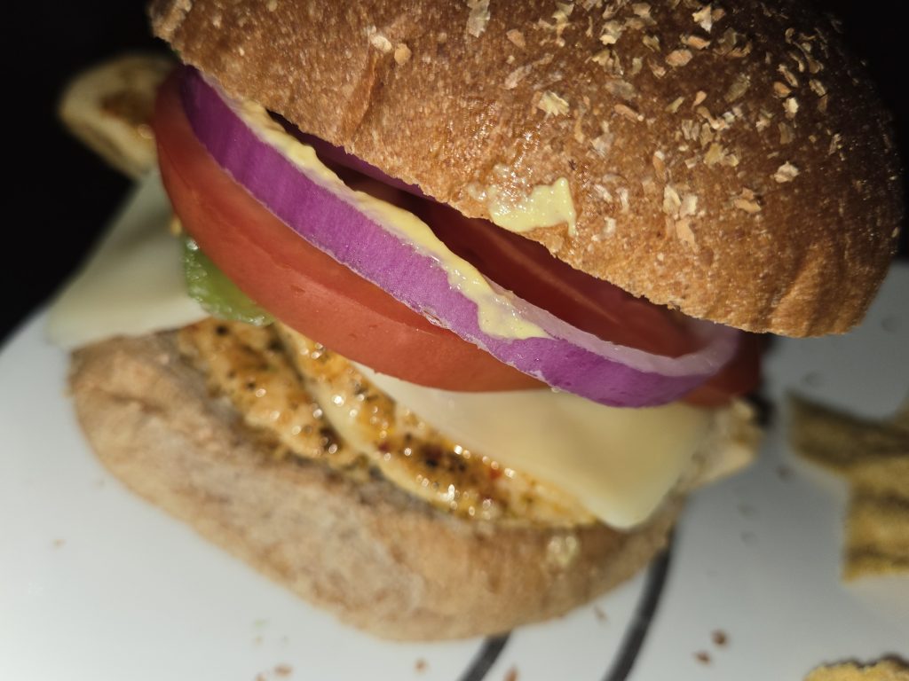 Grilled chicken sandwich on whole wheat bread.