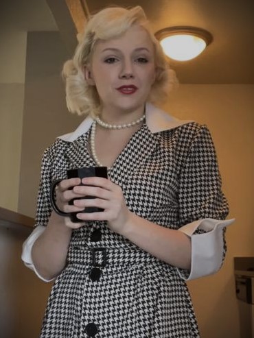 Jenni wearing a black and white dress.