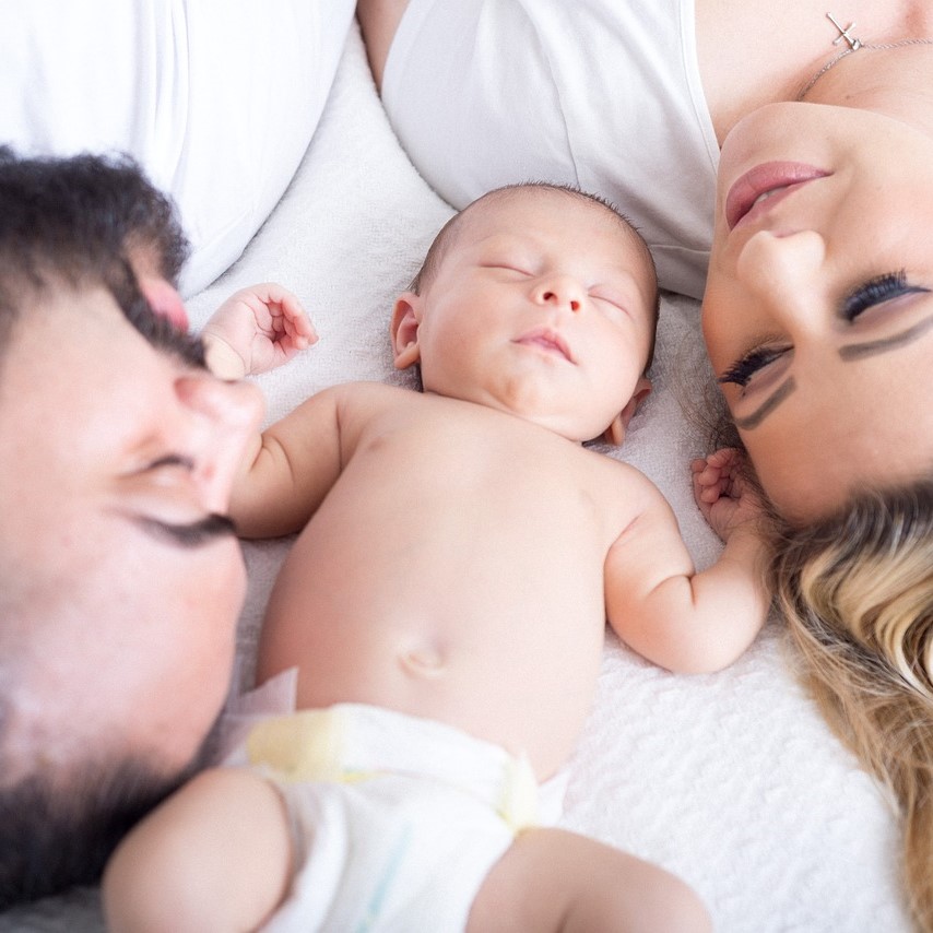 Parents with a baby, family photo.