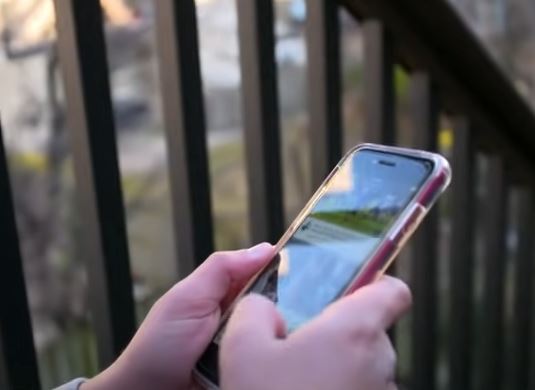 Child using a cell phone to scroll constantly.